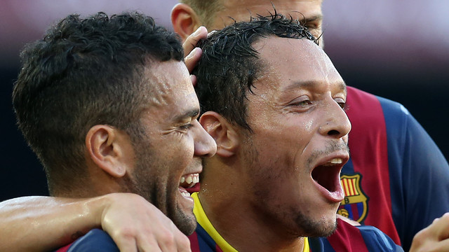 Dani Alves and Adriano celebrate a goal